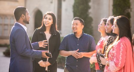Scholars network outdoors on a university campus