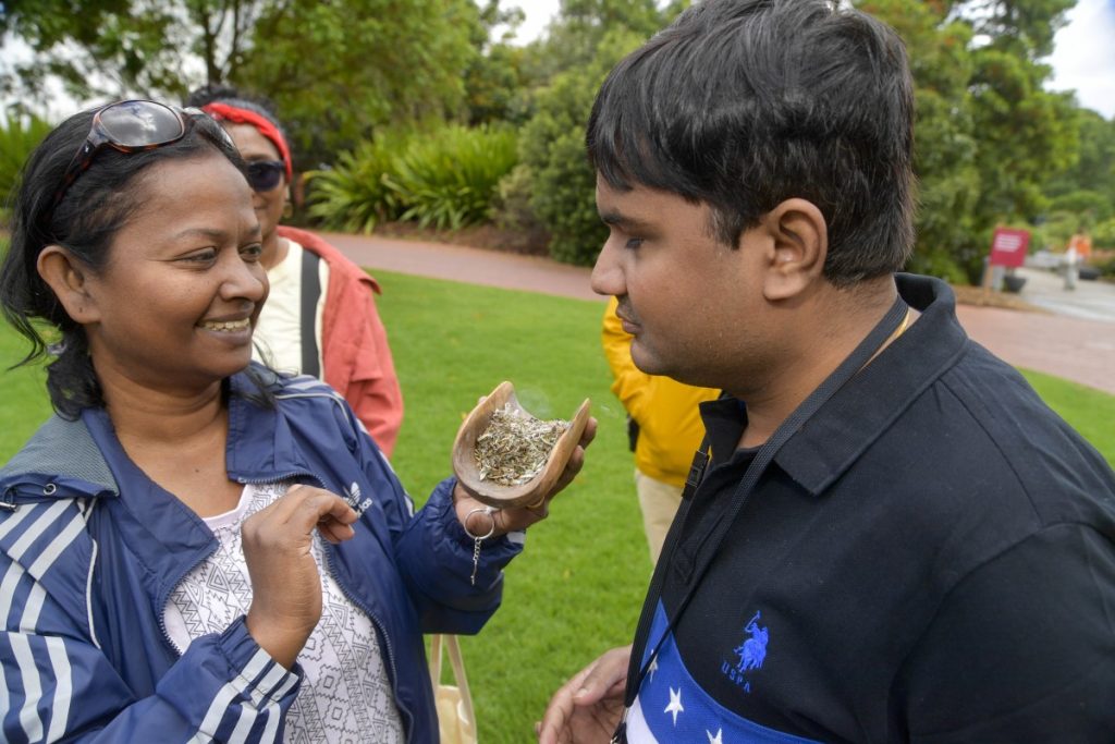 Suganthi (left) and APO participant Amar Jain (right) participating in a smoking ceremony at the Adelaide Botanic Gardens.